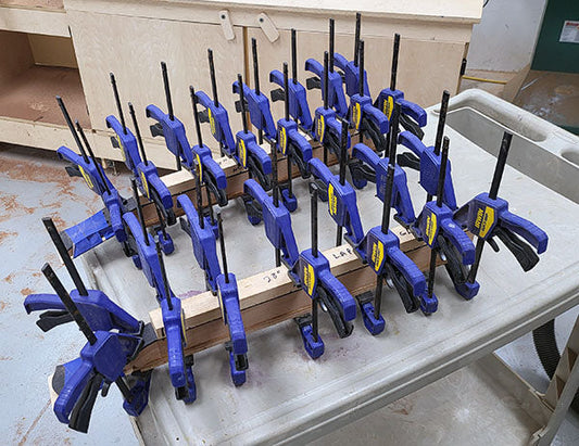 two folkcraft Lap-jo pro necks with clamps on them