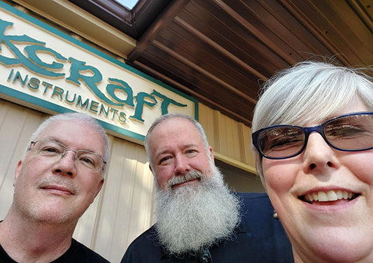 from left to right: john keane, richard ash, and karen keane in front of the folkcraft shop sign