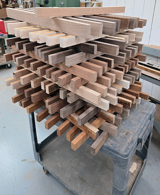 tall stack of Folkcraft fretboard blanks drying on a cart