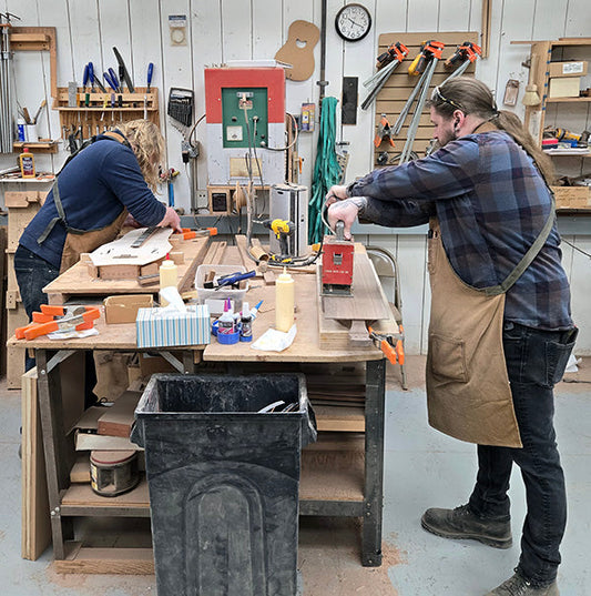 casey and cheyenne working side by side assembling a folkcraft dulcimers