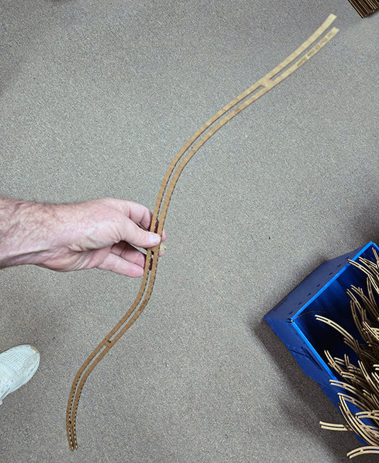 richard ash holding a side guide for a folkcraft cardboard dulcimer kit