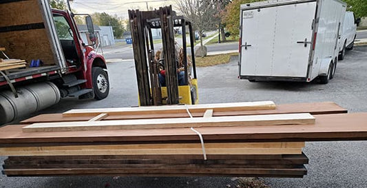 A new load of lumber - huge lumber - on a forklift outside Folkcraft Instruments