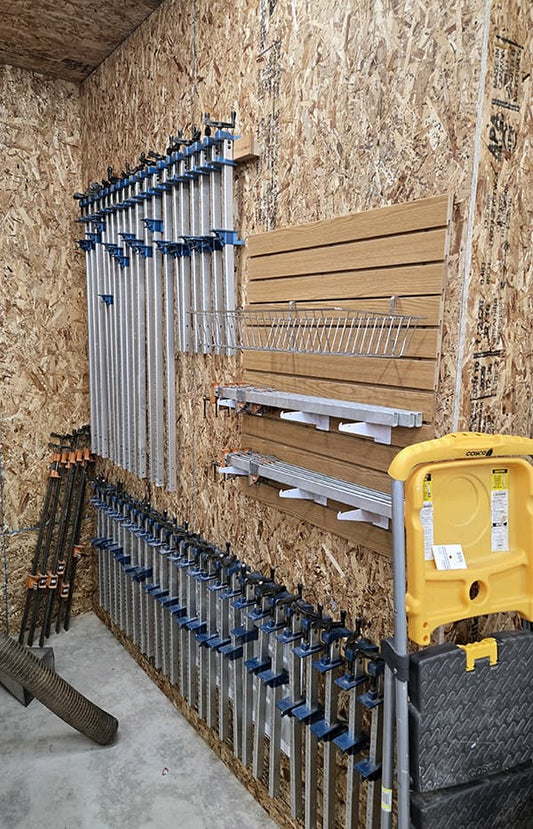 wall in the new Folkcraft workshop which holds many of their bar clamps