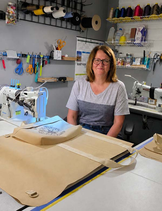 Folkcraft's case-maker extraordinaire, Pam, in her new sewing room with a FolkRoots case she's making