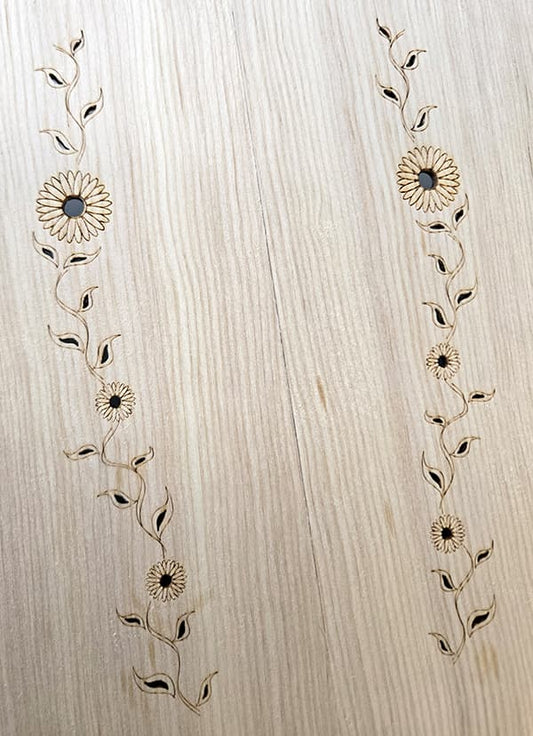 Newly cut trailing sunflower and vines sound holes on a Sitka spruce Folkcraft dulcimer top