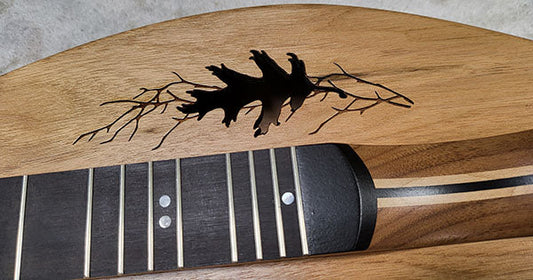 oak leaf and branches sound holes on a folkcraft dulcimer top