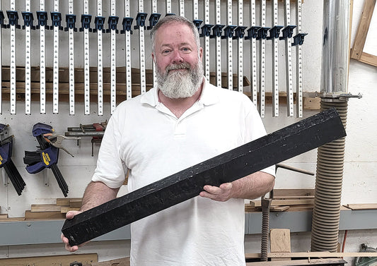 richard ash holding a three foot long gabon ebony board